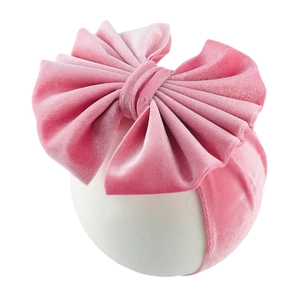 Detail of soft pink velvet oversized layered bow headband for babies on white background
