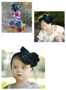 Detail of dark green velvet baby headband featuring a large textured bow design