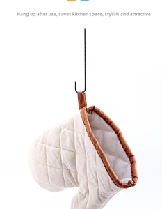 Thickened quilted cotton oven mitt with brown trim hanging on a hook for storage