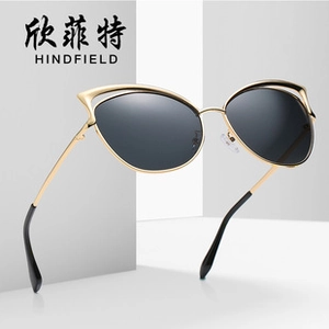 Detailed view of retro oversized cat-eye sunglasses with gradient lenses and gold metal frames