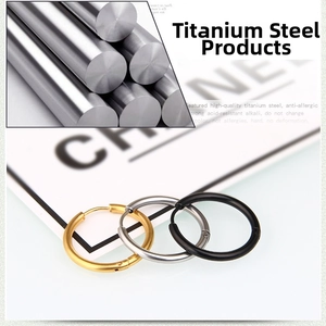 Detail view of titanium steel hoop earrings set in gold, silver, and black finishes
