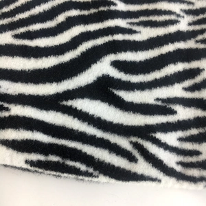 Detailed close-up of soft black and white zebra pattern knitted fabric texture