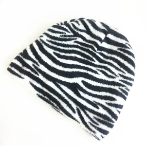 Winter knitted beanie with black and white zebra pattern on a plain white background
