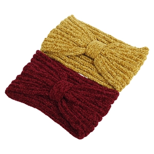 Detail of ginger and wine red knotted knit headbands with soft chenille texture