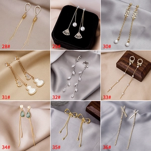 Selection of nine long tassel earrings with rhinestones, pearls and enamel charms