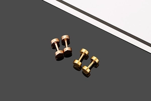 Detailed view of rose gold and gold dumbbell screw earrings made of polished stainless steel