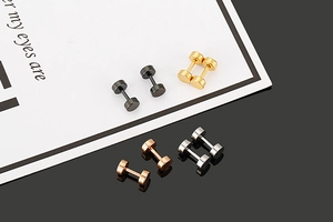 Detailed display of minimalist stainless steel barbell studs in black, gold, silver, and rose gold
