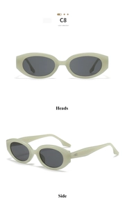 Detail view of oval cream sunglasses with dark grey lenses and metal hinge accents