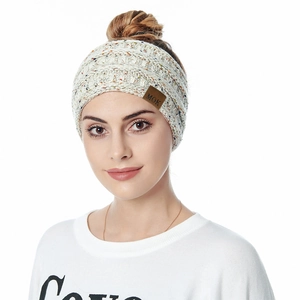 Close-up of beige knitted winter headband with colorful flecks and brown leather MOK label