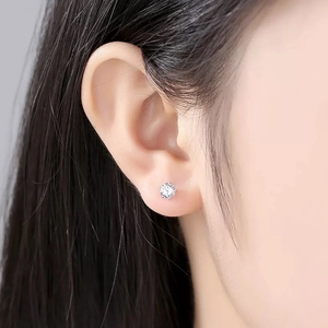 Detailed close-up of a S999 sterling silver stud earring with sparkling cubic zirconia