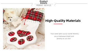 Detail of pet Christmas stocking featuring red plaid dog paw design and bone charms