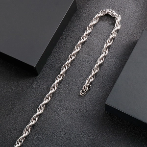 Detailed view of silver titanium steel interlocking chain necklace with high gloss finish