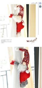 Close-up of festive Christmas gnome curtain tiebacks with red knitted hats and white beards