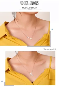 Model wearing stainless steel collar necklace with minimalist H and X letter pendants