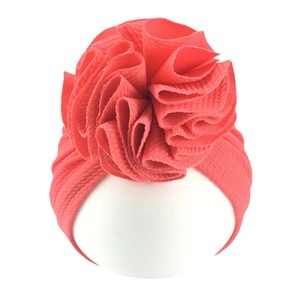 Detail of waffle texture baby turban in watermelon red with large flower decor