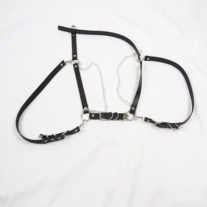 Detail of a black punk leather body harness with silver metal rings and chains