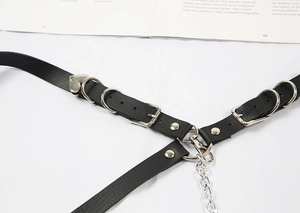 Close-up of gothic punk black leather belt strap with silver heart metal buckle
