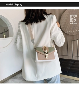 Detail view of stylish tricolor flap crossbody bag with gold chain and wide fabric strap
