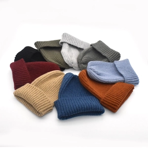 Multi-color rib-knit winter beanies stacked in a circular display on a white background