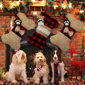 Detailed view of bone-shaped burlap Christmas stockings with plaid patterns and paw prints