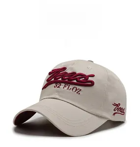 Macro view of burgundy embroidery on a beige cotton baseball cap with Trends text