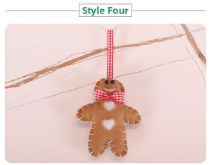 Handmade gingerbread man felt ornament with red bow and heart details for Christmas tree