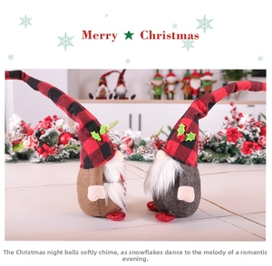 Detail of Christmas gnome plush with buffalo plaid hat, holly leaves, and white beard