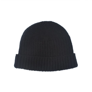 Detail of black ribbed knit beanie showing high-quality wool texture and folded cuff
