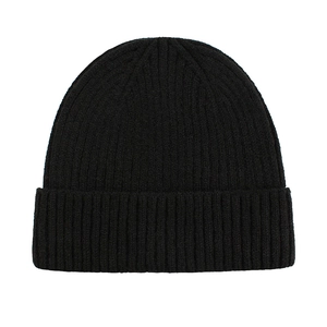 Close-up of black ribbed knit texture on a minimalist winter beanie hat