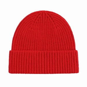 Close-up of vibrant red knitted beanie showing detailed ribbed texture and soft fabric