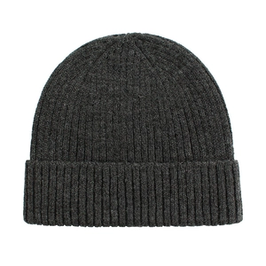 Close-up of deep gray knitted beanie showing detailed ribbed texture and warm fabric
