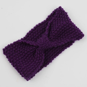 Detail of purple corn kernel knit headband featuring a bohemian twisted knot design