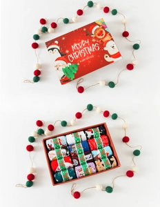 Detailed view of an open Christmas gift box featuring cartoon Santa and reindeer socks