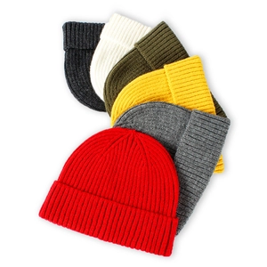 Vertical rib-knit beanie hats for men and women in various solid colors including red and green