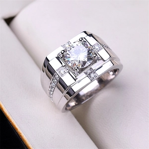 Men's silver moissanite ring with a large round center stone and wide side-set diamonds