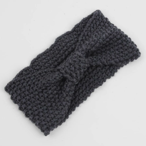Close-up of dark grey chunky knit headband featuring a bohemian twisted knot bow texture