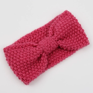Detailed knit texture of a magenta bohemian headband with a centered decorative bow