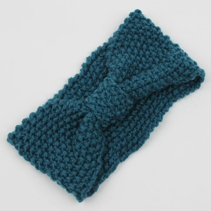 Close-up of textured corn grain knit ear warmer headband with a center twist in teal