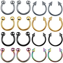 Detailed set of horseshoe body piercing rings in silver, gold, black, and rainbow steel
