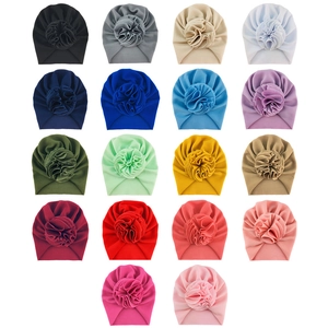 Flat lay of baby waffle sunflower headwraps in 18 diverse colors on white background