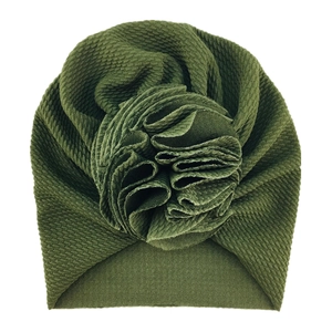 Detail of olive green waffle knit baby turban hat featuring a large fabric flower decor