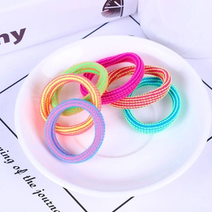 Close-up of colorful seamless elastic nylon hair bands in a white decorative tray