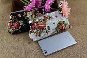 Floral canvas purses with metal frame closure and retro rose patterns on burlap background