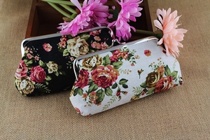 Close-up of retro floral canvas pouches with vintage silver metal frame clasps