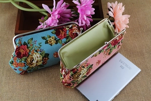 Detail of floral canvas coin purse with vintage rose print and silver metal clasp closure