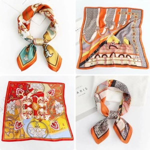 Detail of silk-like square scarf featuring elegant orange and red printed patterns
