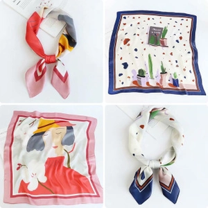 Detail of multi-patterned silk square scarves featuring botanical and portrait prints