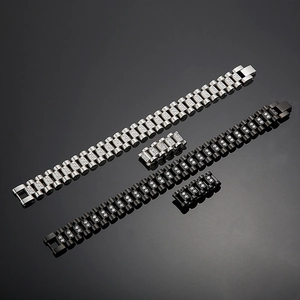 Detailed view of silver and black stainless steel watchband style bracelets with zircon