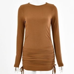 Detail of brown ribbed knit dress featuring adjustable side drawstrings and ruched texture
