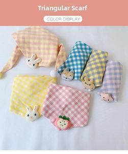 Close-up of colorful plaid cotton triangular scarves with 3D cartoon plush ornaments